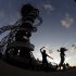 In this Friday, Aug. 3, 2012 photo, two women dance to music on loudspeakers under the Orbit attraction at Olympic Park during the 2012 Summer Olympics, in London. (AP Photo/Charlie Riedel)