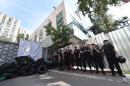 Police gather in front of the entrance of the TV channel "Inter" during a protest by activits in Kiev