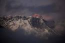 FILE – In this Oct. 27, 2011 file photo, the last light of the day sets on Mount Everest as it rises behind Mount Nuptse as seen from Tengboche, in the Himalaya's Khumbu region, Nepal. The Everest climbing season began March 2014 with new rules that require climbers to bring down at least eight kilograms (17.6 pounds) of their personal garbage, and more security officials at the mountain's base camp to help climbers. More than 4,000 climbers have scaled the 8,850-meter (29,035-foot) summit since it was conquered in 1953 by Edmund Hillary and his Sherpa guide Tenzing Norgay. Over the years, climbers have left tons of garbage on the slopes on the mountain, and some have called it the "world's highest garbage dump." (AP Photo/Kevin Frayer, File)