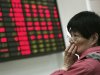 An investor looks at the stock price monitor at a private securities company Thursday, March 22, 2012, in Shanghai, China. Asian stock markets fell Thursday after mixed U.S. housing data and disappointment over the limited scope of China's latest monetary loosening maneuver kept investors on the sidelines. (AP Photo)