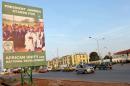 File photo shows cars driving past a campaign poster for Gambian President Yahya Jammeh in the capital city of Banjul on November 22, 2011