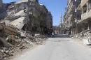 A resident walks past damaged buildings in the Damascus suburb of Zamalka