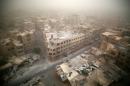 A general view of damaged buildings is seen in the rebel-held area of Douma, Syria as a sandstorm blows over the city on September 7, 2015