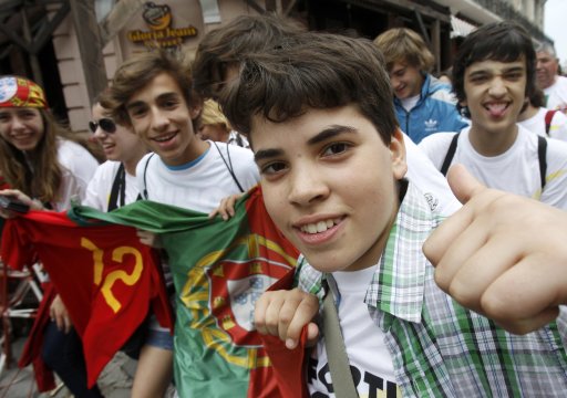 Portuguese fans wave flags and tee-shirts as they party in Lviv