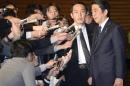 Japanese Prime Minister Shinzo Abe, right, speaks to reporters at his official residence following a new message purported to be from the Islamic State group, in Tokyo early Sunday, Jan. 25, 2015. Japanese officials are working to verifying the new message purported to be from the Islamic State group holding two Japanese hostages. The Associated Press could not verify the contents of the message, which varied greatly from previous videos released by the Islamic State group, which now holds a third of both Syria and Iraq. (AP Photo/Kyodo News) JAPAN OUT, CREDIT MANDATORY Japanese Prime Minister Shinzo Abe, right, speaks to reporters at his official residence following a new message purported to be from the Islamic State group, in Tokyo early Sunday, Jan. 25, 2015. Japanese officials are working to verifying the new message purported to be from the Islamic State group holding two Japanese hostages. The Associated Press could not verify the contents of the message, which varied greatly from previous videos released by the Islamic State group, which now holds a third of both Syria and Iraq. (AP Photo/Kyodo News) JAPAN OUT, CREDIT MANDATORY