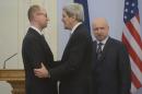 U.S. Secretary of State John Kerry, center, greets Ukrainian Prime Minister Arseniy Yatsenyuk, left, parliament speaker Oleksandr Turchynov is seen right prior their meting in Kiev, Ukraine, Tuesday, March, 4, 2014. In a somber show of U.S. support for Ukraine's new leadership, Secretary of State John Kerry walked the streets Tuesday where nearly 100 anti-government protesters were gunned down by police last month, and promised beseeching crowds that American aid is on the way. The Obama administration announced a $1 billion energy subsidy package in Washington as Kerry was arriving in Kiev. (AP Photo/Andrew Kravchenko, pool)