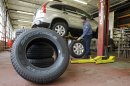 In this Thursday, April 26, 2012, photo, new Goodyear tires sit in a service bay at Conrad's Total Car Care center in North Olmsted, Ohio. Goodyear said Friday, April 27, 2012, sales increased 2 percent and revenue per-tire rose 16 percent, but $86 million in refinancing charges to land lower interest rates dragged it to an $11 million loss for the first quarter. (AP Photo/Mark Duncan)
