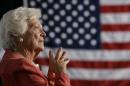 File photo of former U.S. first lady Barbara Bush listening to her son President George W. Bush at an event in Orlando.
