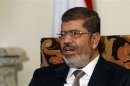 Egyptian President Mohamed Mursi talks during an interview with Reuters at the Presidential palace in Cairo