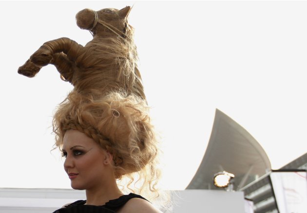 Model wearing hat designed from hair in shape of horse, poses during 17th Dubai World Cup at Meydan racecourse in Dubai