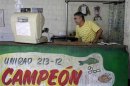 A butcher stands inside a subsidized butcher shop in Havana