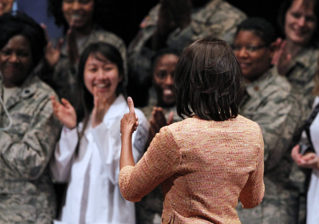 First lady Michelle Obama gives thumbs up as she arrives at the University of Pennsylvania in Philadelphia, Wednesday, April 11, 2012, to announce a major initiative by more than 150 of America's lead