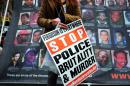A protester displays a placard at the Union Square in New York on April 14, 2015 during a demonstration against the fatal shooting of Walter Scott by a South Carolina police officer