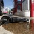 A fuel pump nozzle lays in a puddle of gasoline after it was disconnected from the hose at a station in Arlington