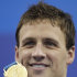 U.S. Ryan Lochte shows the gold medal he won in the men's 200m Backstroke final at the FINA Swimming World Championships in Shanghai, China, Friday, July 29, 2011. (AP Photo/Michael Sohn)