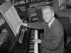 FILE - In this May 2, 1960 file photo, Pulitzer Prize winning composer Elliott Carter poses at the piano in his New York City apartment after the announcement of the award was made. Carter, a classical composer whose challenging, rhythmically complex works earned him widespread admiration and two Pulitzer Prizes, died Monday, Nov. 5, 2012 at age 103. (AP Photo/John Lent, File)