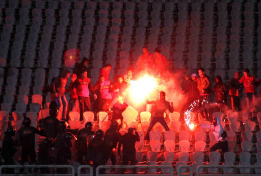 Egyptian fans clash with riot police following Al-Ahly club soccer match against Al-Masry club at the soccer stadium in Port Said, Egypt Wednesday, Feb. 1, 2012. Some dozens of Egyptian soccer fans were killed Wednesday in violence following a soccer match in Port Said, when fans flooded the field seconds after a match against a rival team was over, Egypt's Health ministry said. (AP Photo)