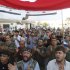 Members of the Free Syrian Army and residents shout slogans during a protest against Syria's President Bashar al-Assad in Sermada near Idlib