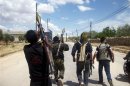 Members of the Free Syrian Army walk as they carry RPGs at Bab Al Hawa in outskirts of Idlib, near the Syrian-Turkey border