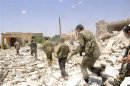 Forces loyal to Syria's President Assad carry their weapons during an operation in Aleppo