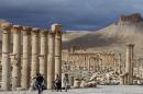 Syrians ride their bikes in the ancient oasis city of Palmyra in March 2014