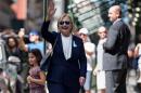 US Democratic presidential nominee Hillary Clinton waves to the press as she leaves her daughter's apartment building after resting on September 11, 2016, in New York