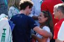 Britain's Andy Murray (L) celebrates with his wife Kim Sears after beating France's Gilles Simon in a Davis Cup match at the Queen's Club in west London on July 19, 2015