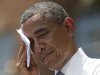 President Barack Obama wipes sweat from his head during a speech on climate change, Tuesday, June 25, 2013, at Georgetown University in Washington. Obama is proposing sweeping steps to limit heat-trapping pollution from coal-fired power plants and to boost renewable energy production on federal property. (AP Photo/Evan Vucci)