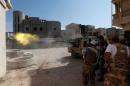Members of Libyan forces allied with the UN-backed government fire a weapon towards Islamic State militants in neighbourhood Number One in central Sirte