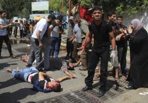 Men inspect dead and wounded Palestinians outside a&nbsp;&hellip;