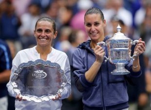 Flavia Pennetta of Italy (R) holds her U.S. Open Trophy next to compatriot Roberta Vinci during the award presentation ceremony following their women'...