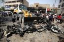 A bulldozer clears the wreckage following a car bomb attack in Sadr City, a Shiite area north of the capital Baghdad, on May 11, 2016
