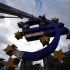 Workers maintain the huge Euro logo next to headquarters of ECB in Frankfurt
