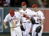 Los Angeles Angels center fielder Mike Trout, left, Josh Hamilton and Peter Bourjos celebrates their 10-9 win against the Seattle Mariners during a baseball game in Anaheim, Calif., Thursday, June 20, 2013. (AP Photo/Chris Carlson)