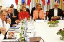 Iranian Foreign Minister Zarif sits next to EU High Representative for Foreign Affairs Mogherini as they meet with foreign ministers from the U.S., France, Russia, Germany, China and Britain in Vienna