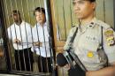 Australian death row prisoners Andrew Chan and Myuran Sukumaran are seen in a holding cell waiting to attend a review hearing in the District Court of Denpasar in Bali