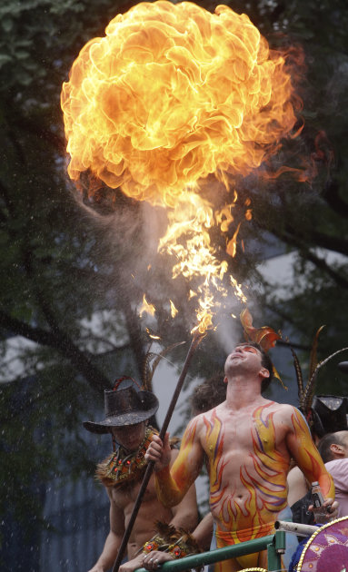 A person performs with fire during the annual Gay Pride Parade in Sao Paulo, Brazil, Sunday June 26, 2011. (AP Photo/Andre Penner)