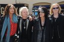 Steven Tyler, from left, Joey Kramer, Joe Perry, and Tom Hamilton of Aerosmith, pose for pictures at the Aerosmith news conference announcing the 2012 Global Warming Tour, Wednesday, March 28, 2012, at The Grove, in Los Angeles. The Global Warming Tour will play 18 markets beginning on June 16, in Minneapolis. (AP Photo/Katy Winn)