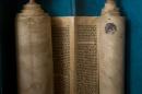 An ancient Torah scroll is seen during a dedication ceremony at the Israeli Foreign Ministry in Jerusalem, Thursday, Jan. 22, 2015. The scroll that Israeli experts said was written 200 years ago has taken an unusual and mysterious journey from Baghdad to Jerusalem where it was greeted with candies and song in a jubilant dedication ceremony Thursday. (AP Photo/Sebastian Scheiner)