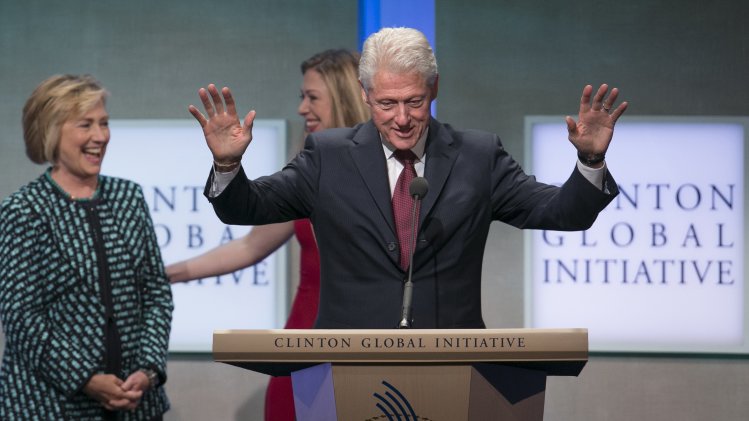 Former U.S. Secretary of State and former first lady Hillary Clinton and daughter Chelsea share a laugh while former U.S. President Clinton speaks at the Clinton Global Initiative 2013 (CGI) in New York