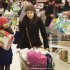 Shoppers move through the cashier area at a Morrisons supermarket ahead of Christmas weekend in London