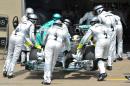 Mercedes driver Lewis Hamilton of Britain is pushed into his garage after retiring during the Canadian Formula One Grand Prix at the Circuit Gilles Villeneuve in Montreal on June 8, 2014