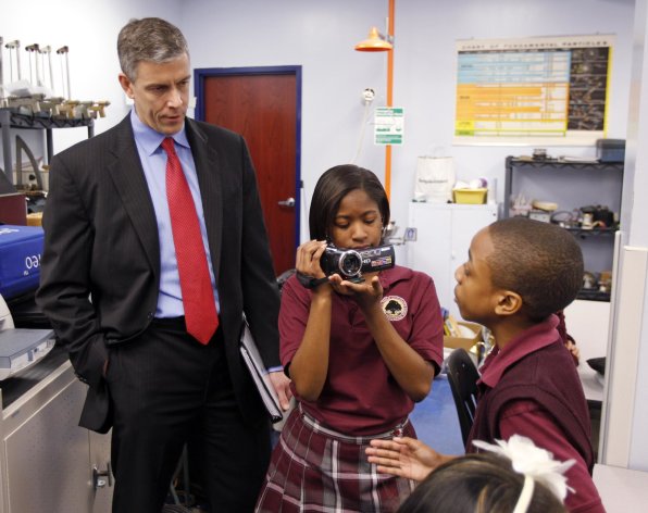 In this Friday, April 15, 2011 photo, U.S. Department of Education Secretary Arne Duncan is questioned by student Trebor Goodall, right, as he's videotaped by fellow student Faith Brown during a tour of the Charles A. Tindley Accelerated School in Indianapolis. Duncan is a chief proponent of extended hours and a longer school year. The school in Indianapolis has extended hours. (AP Photo/Michael Conroy)