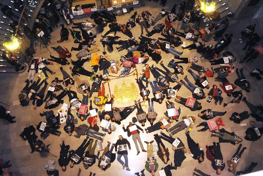 FILE - In a Wednesday Jan. 7, 2015 file photo, about 130 people stage a die-in on the floor of the Missouri State Capitol Rotunda shortly before the...