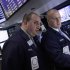 Specialists Peter Giacchi, left, and John Parisi confer on the floor of the New York Stock Exchange Wednesday, April 25, 2012.  U.S. stocks were headed for a neutral opening, with Dow Jones industrial futures nearly unchanged.  (AP Photo/Richard Drew)