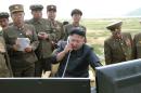 North Korean leader Kim Jung Un guides the test fire of a tactical rocket in this undated photo