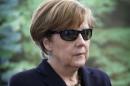 German Chancellor Merkel wears 3D glasses during visit by teenage female students on national 'Girls Day' in Berlin