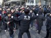 A policeman tries to drag away people who refused to leave the Apple Store in Beijing Friday, Jan. 13, 2012. An angry crowd shouted and threw eggs at Apple's Beijing flagship store after it failed to open on schedule Friday to sell the popular new iPhone 4S model. (AP Photo/Andy Wong)