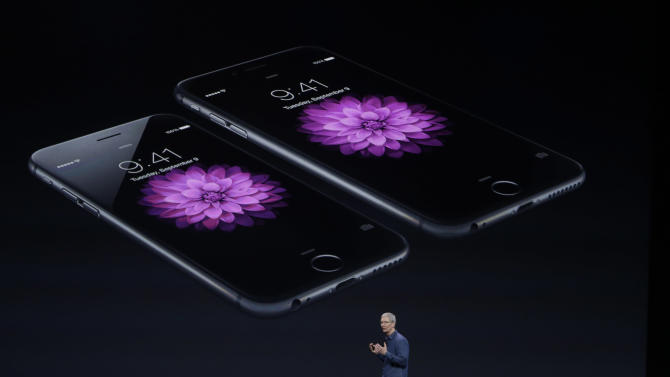 Apple CEO Tim Cook introduces the iPhone 6 on Tuesday, Sept. 9, 2014, in Cupertino, Calif. (AP Photo/Marcio Jose Sanchez)