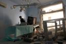 A medic inspects the damage inside Anadan Hospital, sponsored by Union of Medical Care and Relief Organizations (UOSSM), after it was hit yesterday by an airstrike in the rebel held city of Anadan, northern Aleppo province
